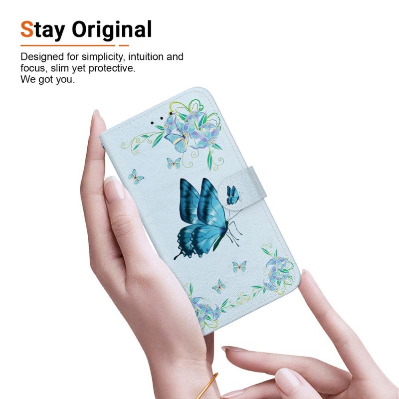 Housse iPhone 16 Plus Papillons Bleus et Fleurs à Lanière